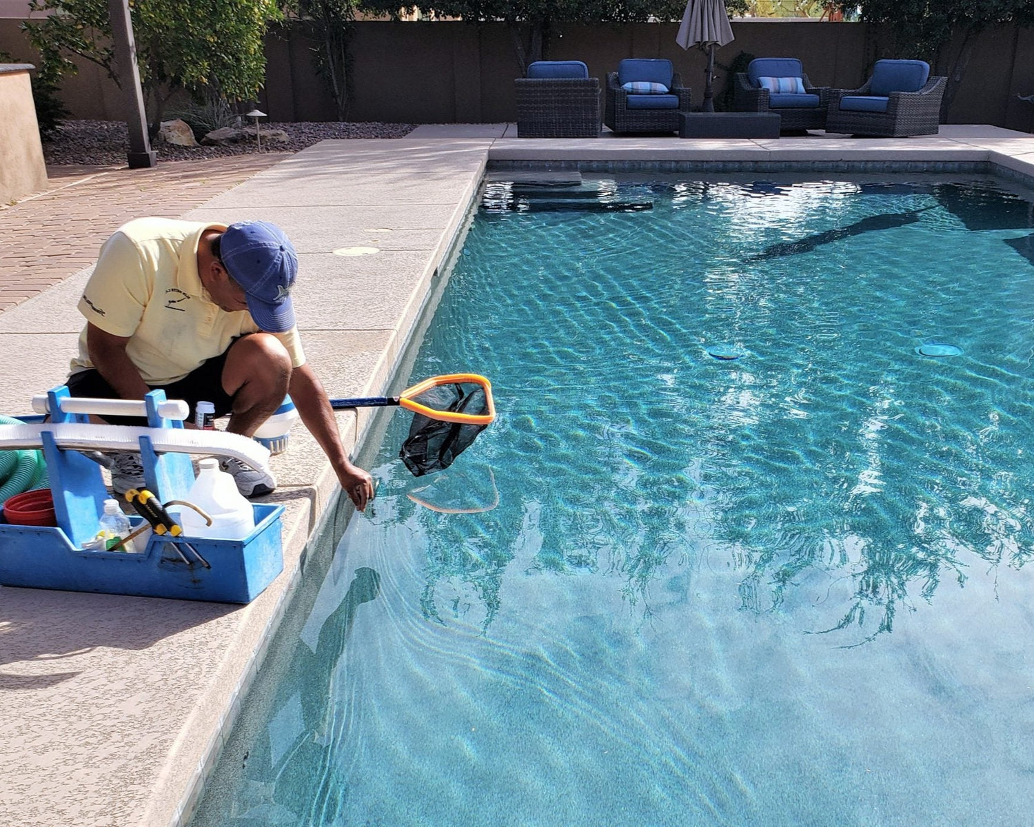 Person cleaning a pool with cleaning equipment