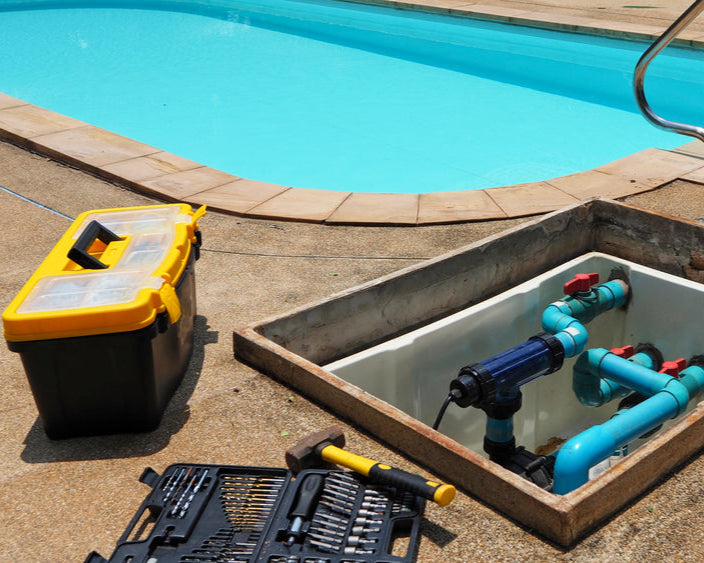 Pool maintenance tools and equipment by a pool