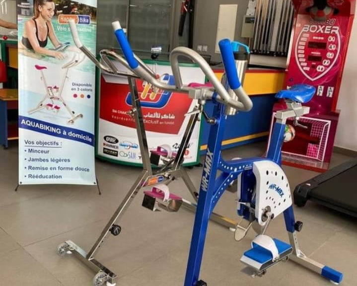 Aqua Fitness equipment on display in a store with a banner in the background.